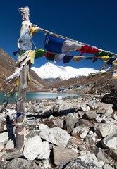 Gokyo lake village with prayer flags and mount Cho Oyu