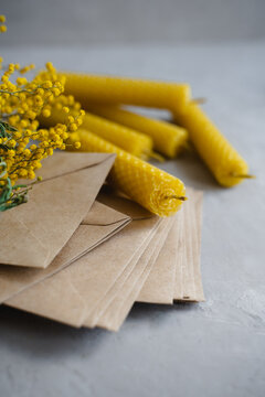 Candles made of natural honey wax. Craft envelopes for letters. Vertical photo.