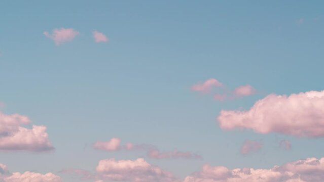 soft pink clouds moving horizontally in pastel blue sky in bright sunny day. spring time environment. blue sky good weather in summer season. cloudy sky atmosphere. beautiful dreamy cloudscape nature