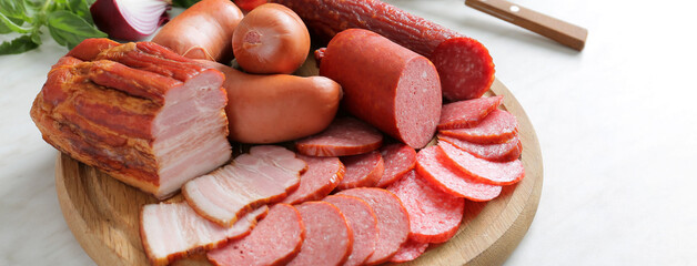 Board with assortment of smoked meat on table