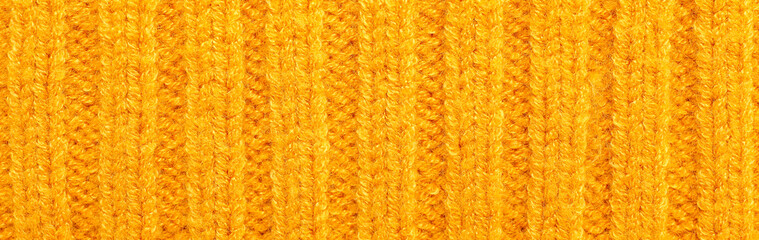 Texture of yellow knitted fabric as background. Banner for design