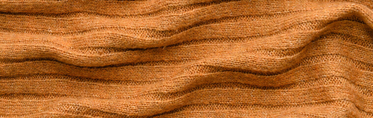 Texture of orange knitted fabric as background. Banner for design