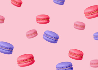 Colorful flying macaroons. Minimal concept. Red, pink and purple french biscuits on pastel backdrop