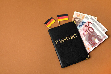 Passport, money and flags of Germany on color background