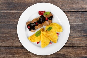 Grilled chicken fillet with herbs on white plate.