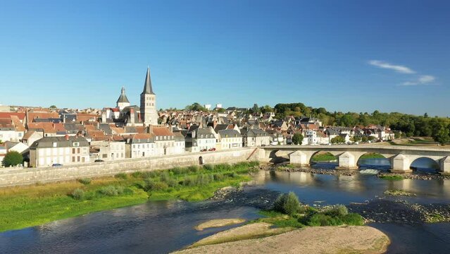 The Charite sur Loire bridge and a dune over the Loire in Europe, France, Burgundy, Nievre, in summer, on a sunny day.