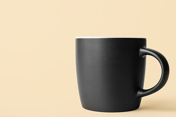 Black ceramic cup on color background