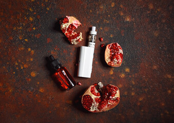 Modern vape mod and pomegranate on color background