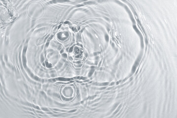 Texture of water with ripples on light background, closeup