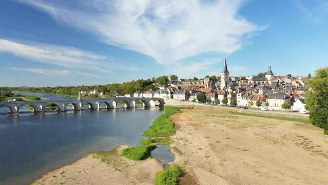 The sandbanks of Charite sur Loire and its stone bridge in Europe, France, Burgundy, Nievre, in summer, on a sunny day.
