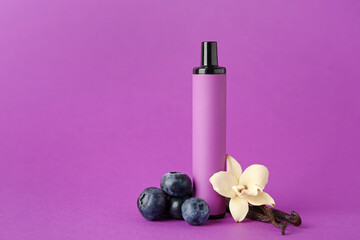 Fototapeta na wymiar Disposable electronic cigarette, blueberries and vanilla flower on purple background