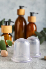 Vacuum jars for anti-cellulite massage on grunge background