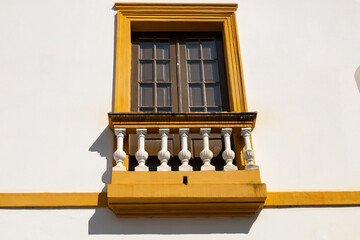 Beautiful architecture - an old balcony with stone railings on the facade of a building in the city center