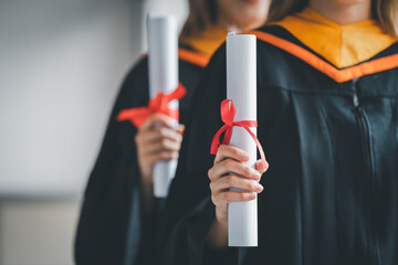 Student holding diploma degree certificate scroll during commencement Graduation graduation...