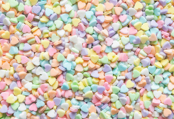 Fototapeta na wymiar multicolor pastel hearts hearts shaped sugar sprinkles background