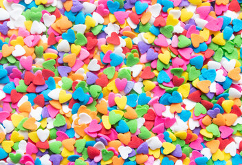 Fototapeta na wymiar Multicolor hearts hearts shaped sugar sprinkles background