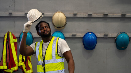African American holding Safety Helmet , Safety helmet equipment in Manufacturing Factory site
