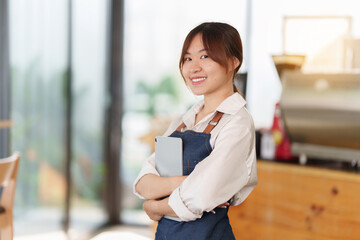 Asian Barista cafe owner smile while cafe open. SME entrepreneur seller business concept.