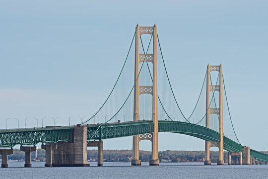 The Mackinaw Bridge is illuminated by the evening sun and carries Interstate 75 connecting Michigan's Upper and Lower Peninsulas. It is one of the longest suspension bridges in the world.