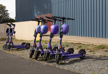 View of a row of parked rental electric scooters - 505049899