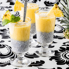 Pineapple puree chia puddings against a abstract vintage background.