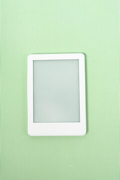 Ebook reader over green striped background
