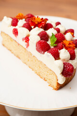 Keto Vanilla Sponge Cake with Raspberries, marigold flowers and fresh mint.