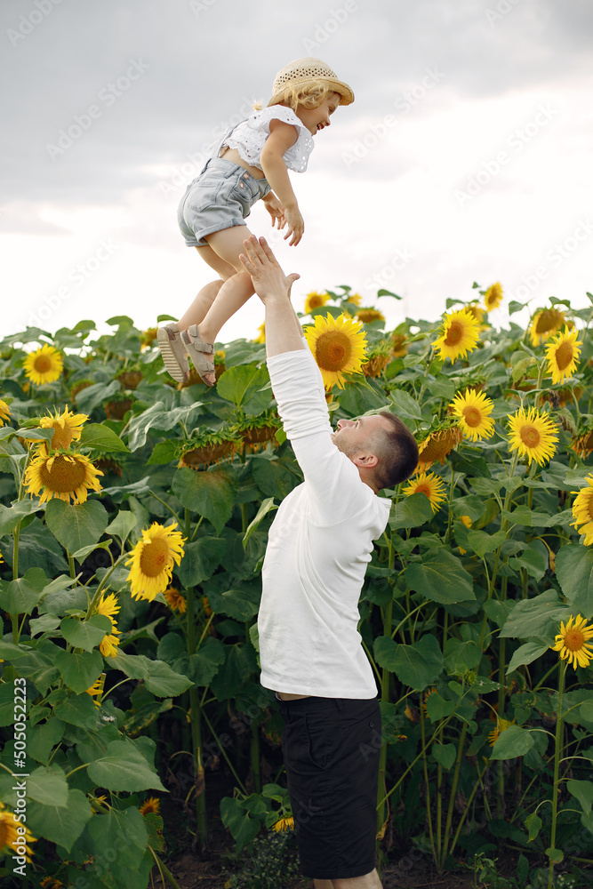 Wall mural cute family playing in a summer field