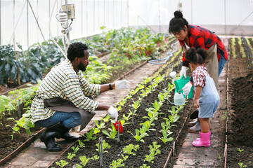 Mixed race family with daughter spending time together at organic's farm. African-American family.