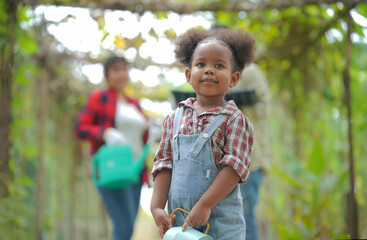 Mixed race family with daughter spending time together at organic's farm. African-American family.