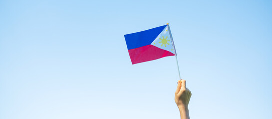 hand holding Philippines flag on nature background. 12th June of Independence day and happy celebration concepts