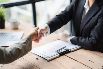 Handshake of businesspeople. Female and male hand makes a handshake in the office, Business people shaking hands, finishing up a meeting.
