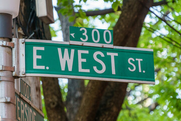 East West Street - an unlikely street sign - obrazy, fototapety, plakaty