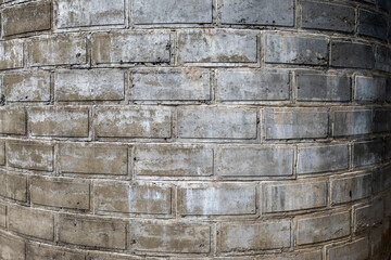 The texture of a round brickwall tower, background or backdrop, grey
