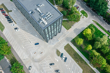 aerial view of parking lot with cars near the business center in residential district