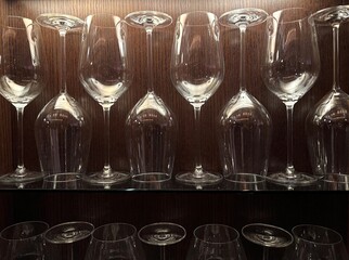 fine crystal wine glasses stored on lighted shelf in an artistic way