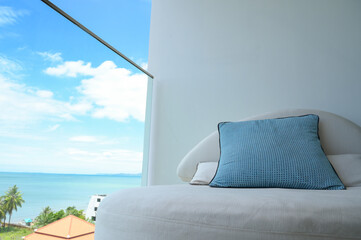 blue pillow on balcony with sky and sea