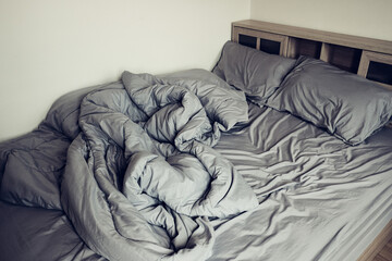 Empty messy gray bed with pillows and blanket. concept of sleep or couple lifestyle.