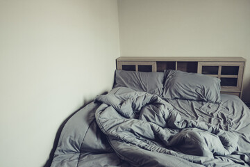Empty messy gray bed with pillows and blanket. concept of sleep or couple lifestyle.