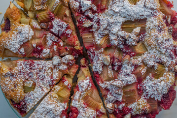 Whole wheat rhubarb raspberry pie with almonds on a table