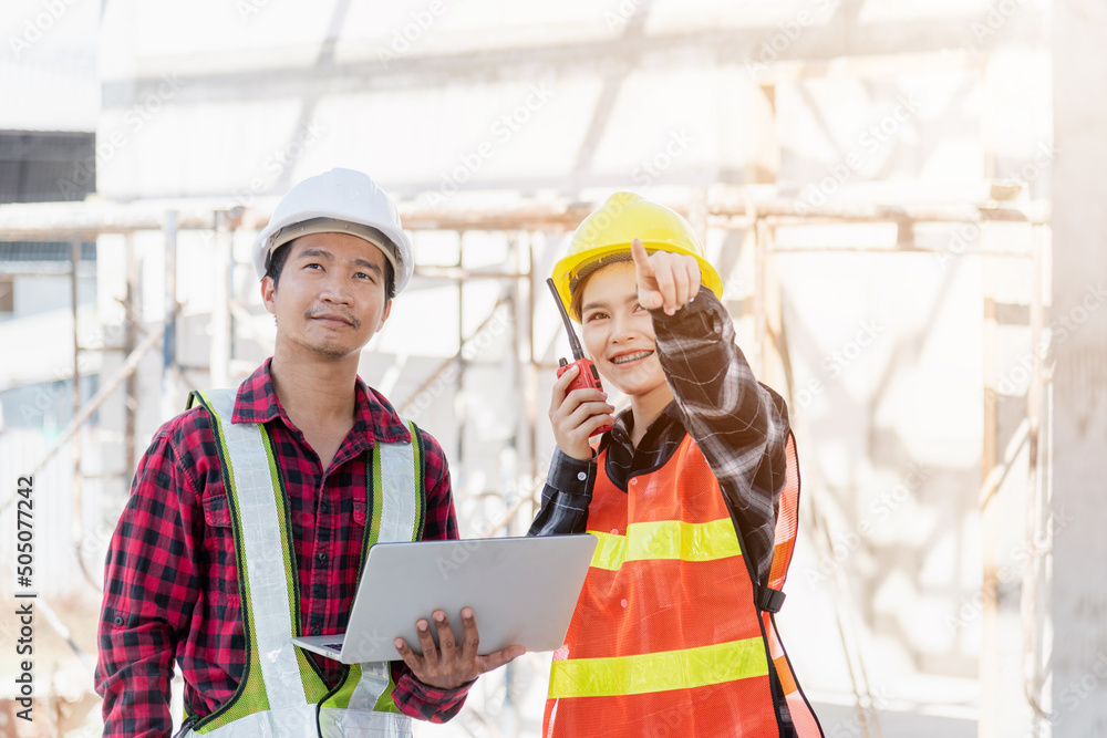 Poster asian engineer foreman worker man and woman working at building construction site use laptop and tal