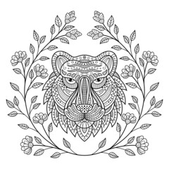 Hand drawn of tiger head with flower frame in zentangle style