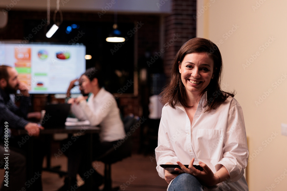 Aufkleber portrait of smiling caucasian woman holding digital tablet working overtime in business office. star