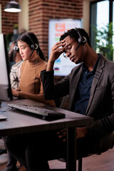 Helpdesk assistant working at call center client care on phone line, using telemarketing equipment....