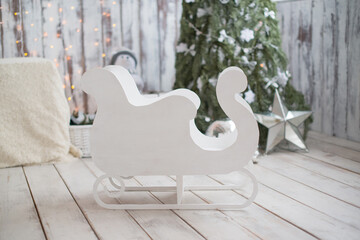 Fototapeta na wymiar Christmas decor, white wooden sled for a child.