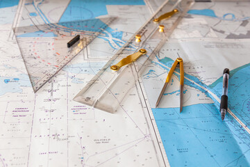 Fototapeta na wymiar Navigation ship chart for building a sailing route. Plotter, divider, ruler and pen on a map.