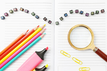 Alphabet blocks with school supplies on opened book