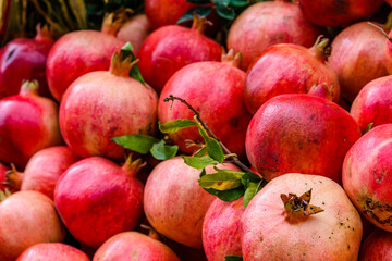 Many pomegranates for sale at the market. Fruit background