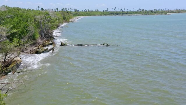 Drone flying over waters along mouth of Soco river, San Pedro de Macoris in Dominican Republic. Aerial forward