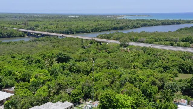 Bridge crossing Soco river, San Pedro de Macoris in Dominican Republic. Aerial forward